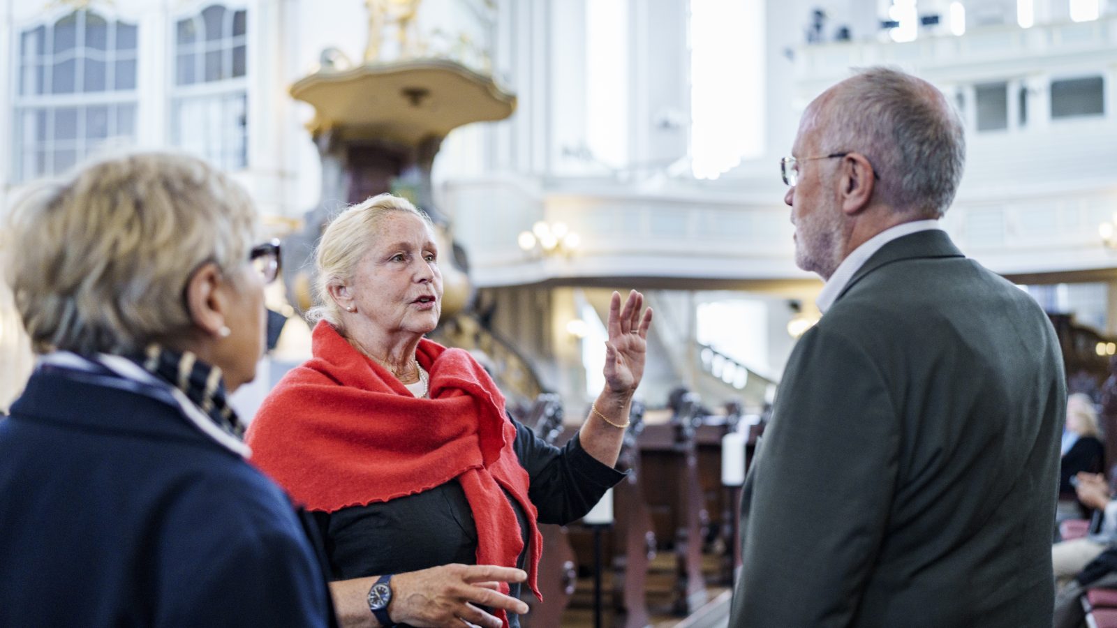 Eine Helferin des Michel gibt Besuchenden Auskunft über die Kirche.
